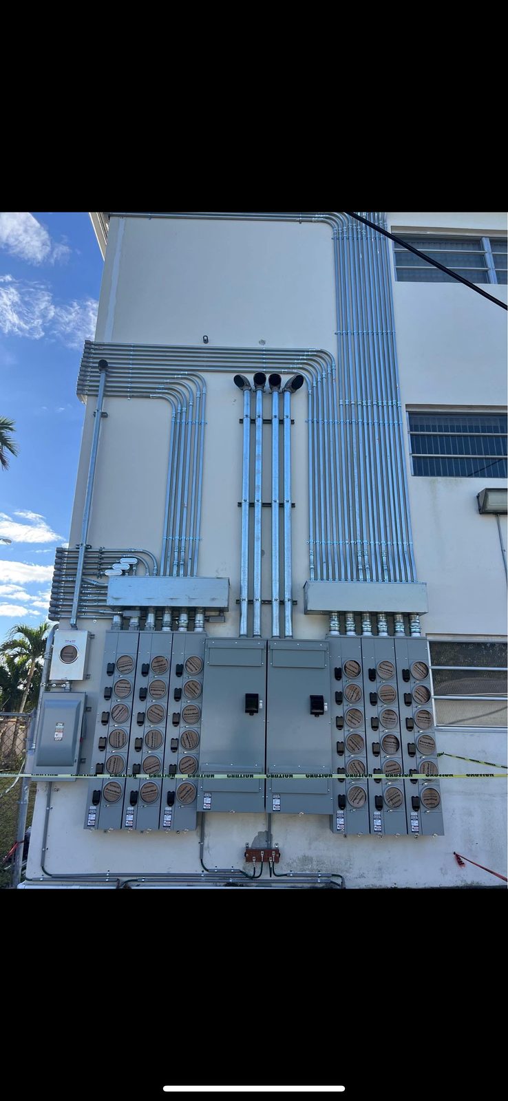 Multi-meter bank with conduit runs on building exterior